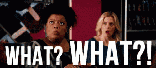 two women are sitting next to each other and one of them is asking what ? what ? !