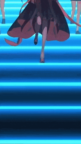 a woman in a long dress is walking down a set of stairs with a group of people behind her .