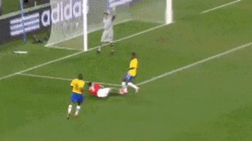 a soccer player in a yellow shirt is kicking another player in a red shirt on a soccer field .