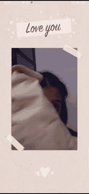 a picture of a woman covering her face with a blanket with the words " love you " written on it