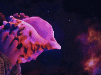 a person is holding a sea shell in front of a galaxy