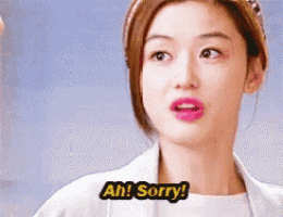 a woman in a white coat is saying ah sorry .