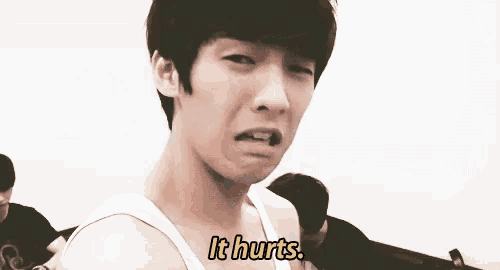 a man in a white tank top says it hurts in yellow letters