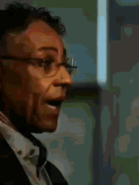 a close up of a man 's face with a name tag on his neck that says dns