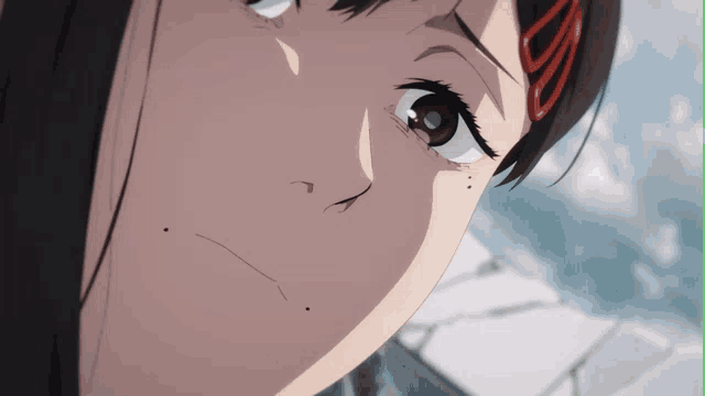 a close up of a girl 's face with a red s on her hair