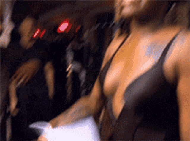 a woman in a plunging neckline bra is standing in a crowd
