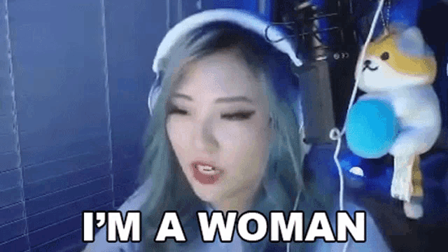 a woman is wearing headphones and says i 'm a woman .
