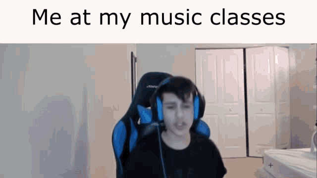 a man wearing headphones sits in a chair with the words " me at my music classes " on the bottom