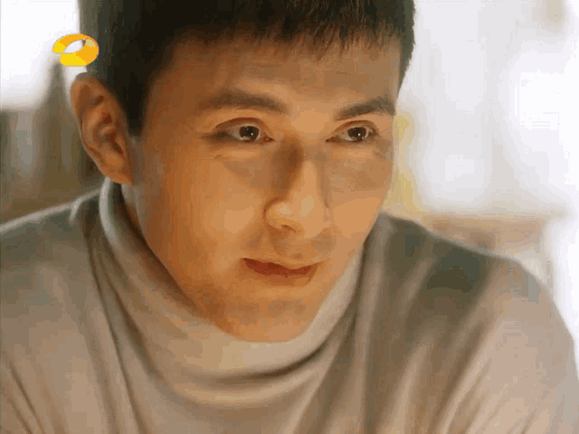 a close up of a man 's face with a yellow circle in the corner