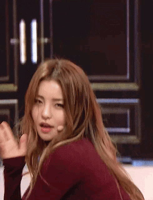 a close up of a woman 's face with a hand on her face