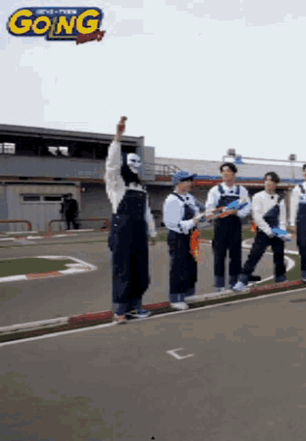 a group of people standing on a race track with the word going on the top