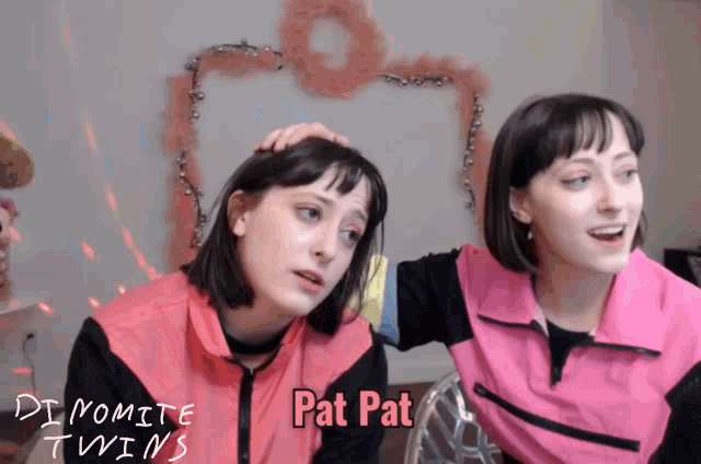 two girls in pink vests with pat pat written on them