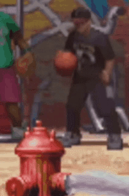 a pixelated image of a man playing basketball next to a fire hydrant