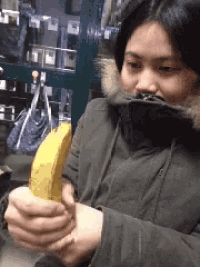 a woman in a fur coat is holding a banana