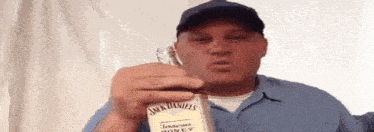 a man is holding a bottle of jack daniels tennessee whiskey