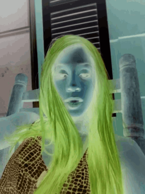 a woman with green hair is in a chair