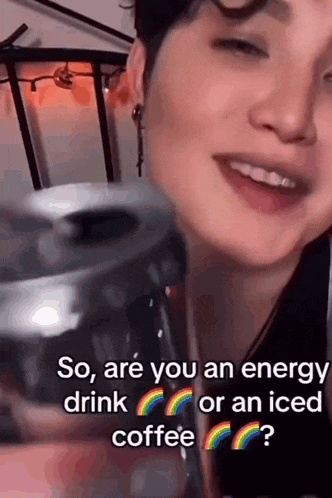 a woman is drinking iced coffee and talking about energy drinks