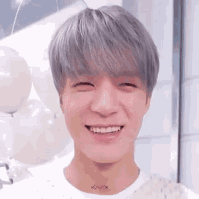 a close up of a person 's face with a smile on their face .
