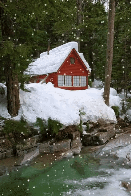 a red cabin in the woods with snow falling around it