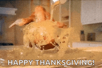 a turkey is being poured into a pan of gravy with the words `` happy thanksgiving '' written on the bottom .