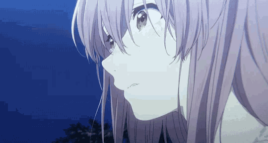 a close up of a girl 's face with pink hair against a blue sky .
