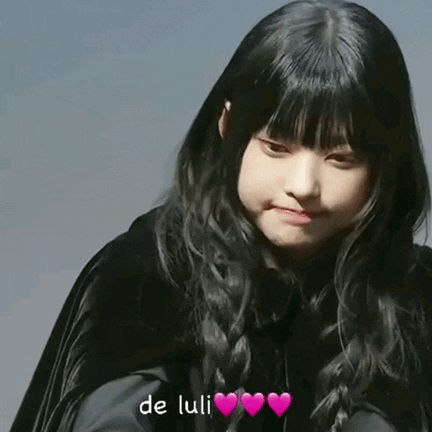 a girl in a black cape with the words de luli written on the bottom