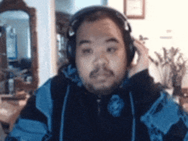 a man wearing headphones and a blue jacket