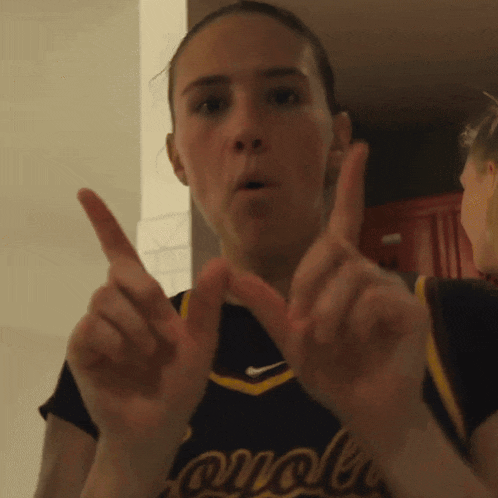 a cheerleader wearing a jersey that says cardinals