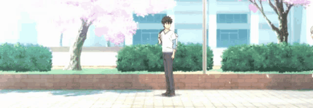 a man in a white shirt is standing in front of a building