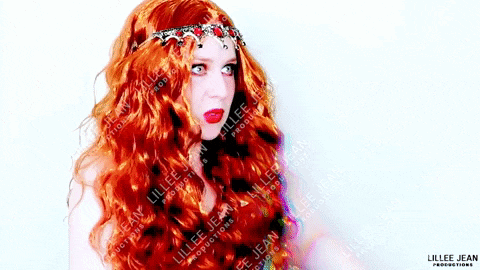 a woman with long red hair is wearing a crown and the name lillee jean is on the bottom right