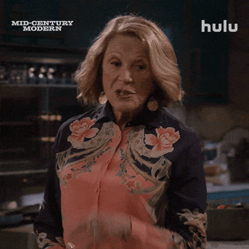 a woman says " say nothing " in front of a hulu sign