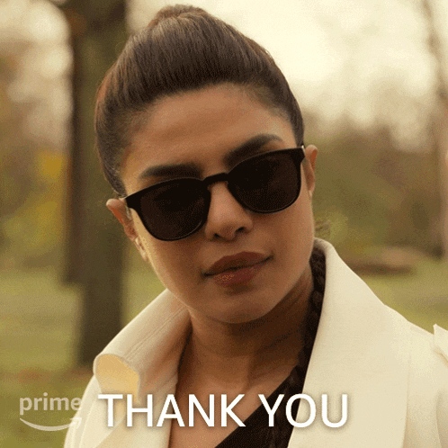 a picture of a woman wearing sunglasses and a white coat with the words thank you on it