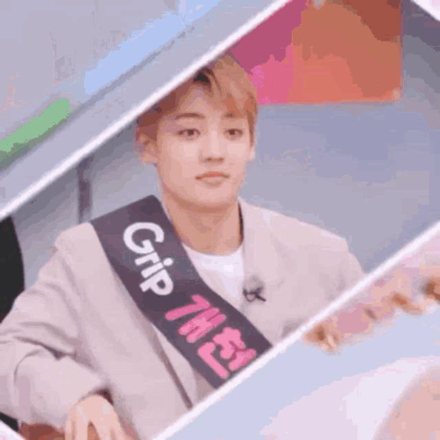a man wearing a sash with the word grip on it