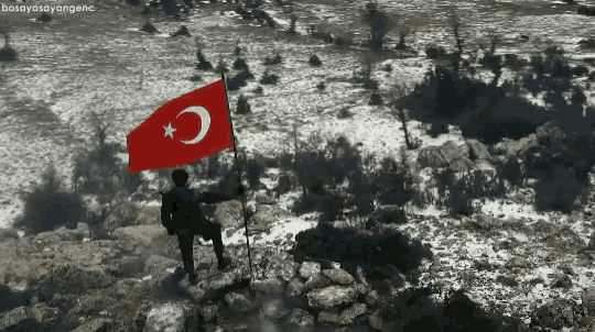 a man holding a flag with a crescent moon and star