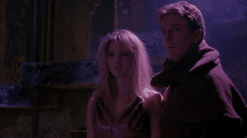 a man and a woman are standing next to each other