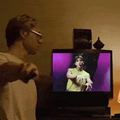 a man is playing a video game on a television while holding a controller