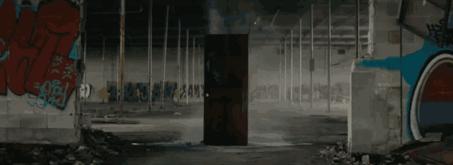 a doorway in an abandoned building with graffiti on the walls including one that says ' i love you '