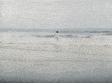 a blurry picture of a person walking on a beach