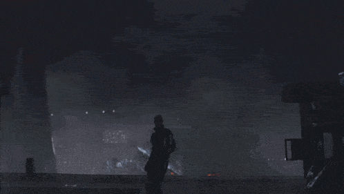 a man is standing in front of a large monster