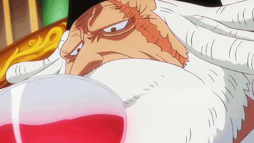 a man with a beard is holding a glass of red liquid in his hand
