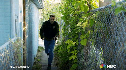 a man in a sheriff 's uniform is running down a nbc advertisement