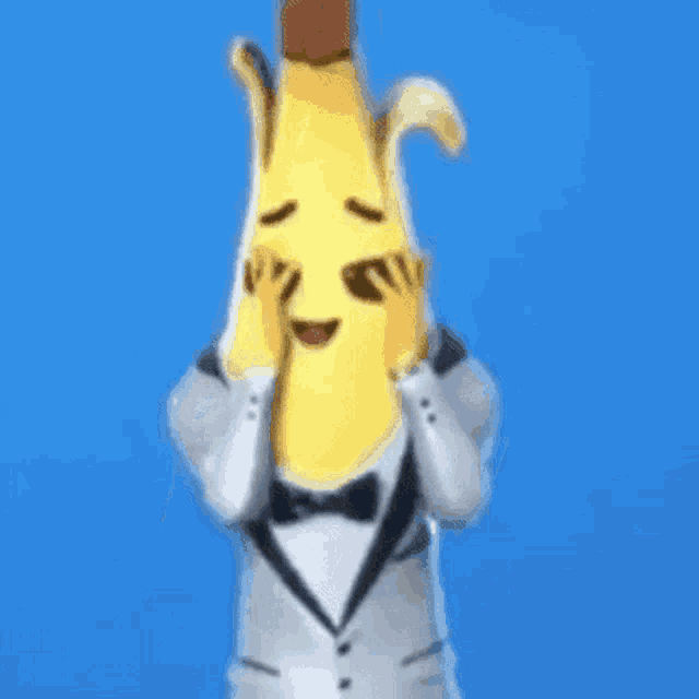 a banana in a tuxedo with a bow tie is standing on a blue background .