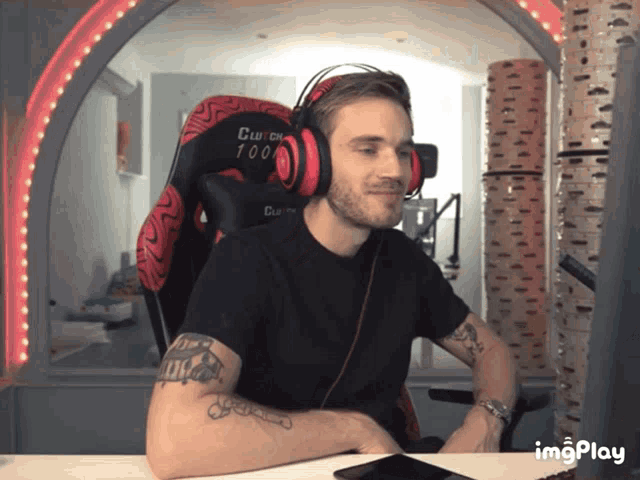 a man wearing headphones is sitting in a chair with the number 100 on it