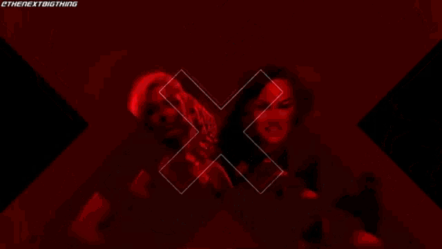 two women are standing next to each other and one has the word extreme written on it