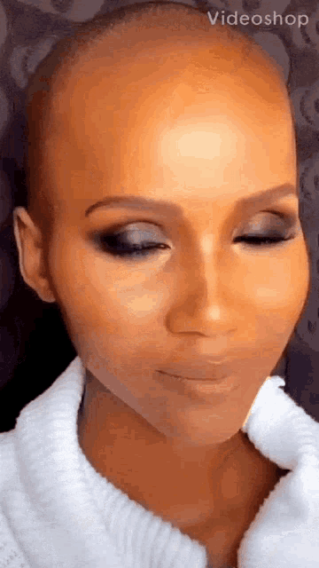 a close up of a woman 's face with her eyes closed .
