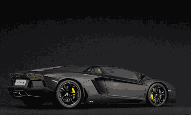 a black lamborghini with yellow circles on the side and a license plate that says leone