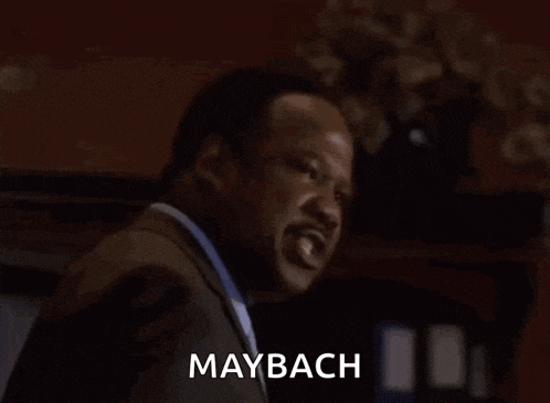 a man in a suit screams with the words shhiiiii maybach below him