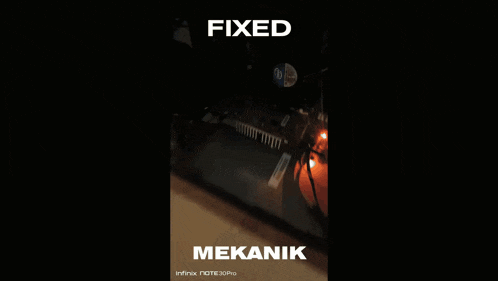 a blurry picture of a person 's hands with the words fixed and mekanik visible