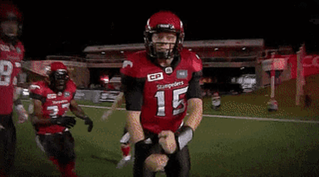 a football player wearing a red jersey and a helmet with the number 10 on it