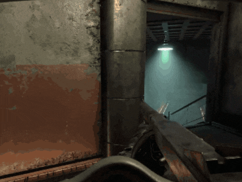 a video game is being played in a dark room with a green light hanging from the ceiling